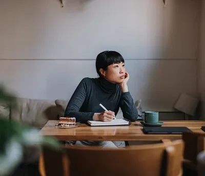 bored and tired woman working remotely from a coffee shop