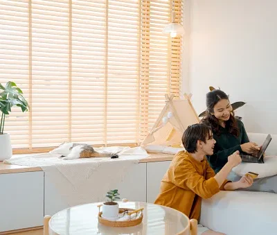 couple online shopping on their digital tablet while relaxing at home