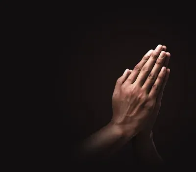 praying hands with faith in religion and belief in god on dark background power of hope or