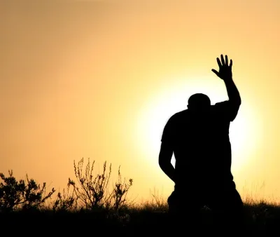 silhouette of man in praise and worship